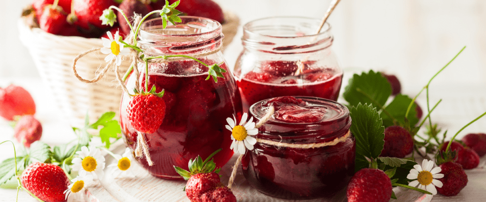 Image of strawberry jam in mason jars.